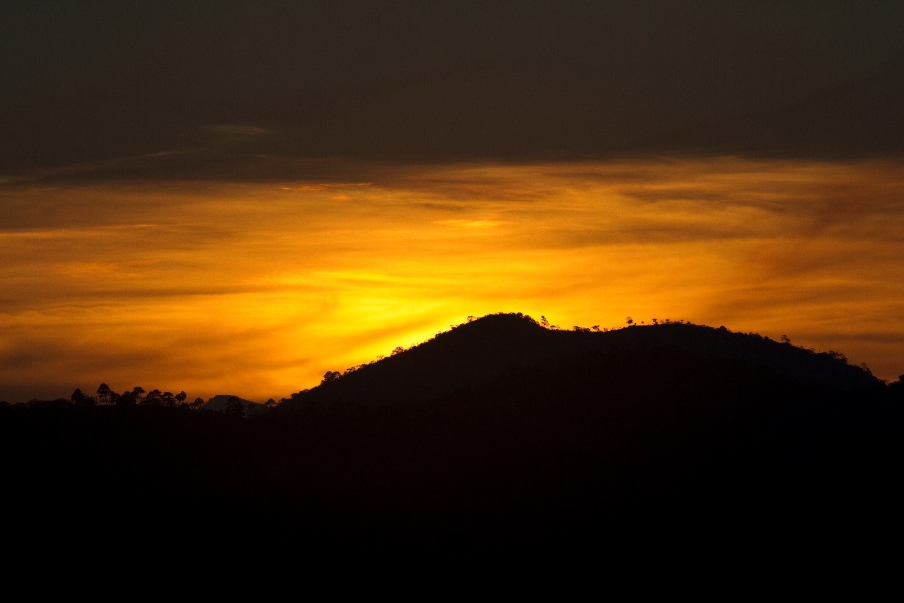 a zoomed in shot of an orange sunset before cropping it into a panoramic shot