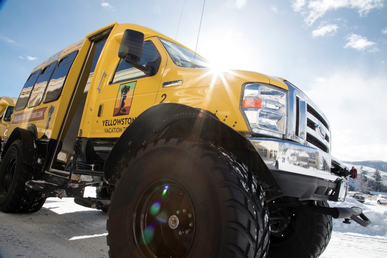 a large-tired truck sits on a launch in yellowstone national park