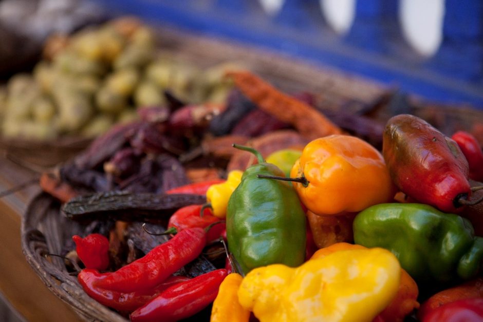 a colorful photo of peppers and other foods at a restaurant in Cusco