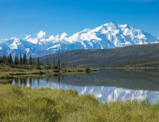a stunning blue sky photo of mt. denali taken from reflection pond