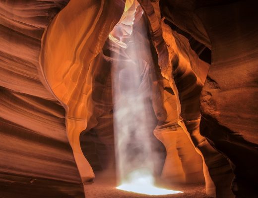 a beautiful sun beam pierces through antelope canyon