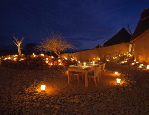 a beautiful al fresco dining scene is underneath a blue evening sky