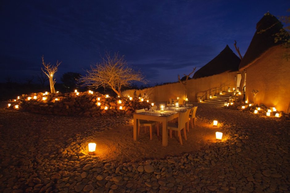 a beautiful al fresco dining scene is underneath a blue evening sky