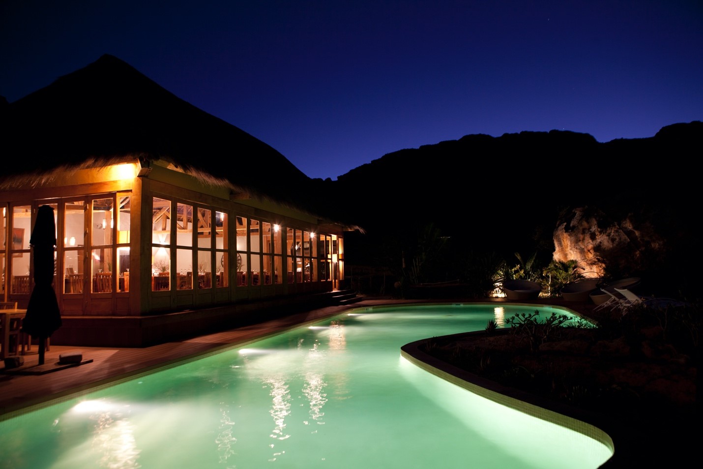 the glow of the pool lights up a lodge in madagascar