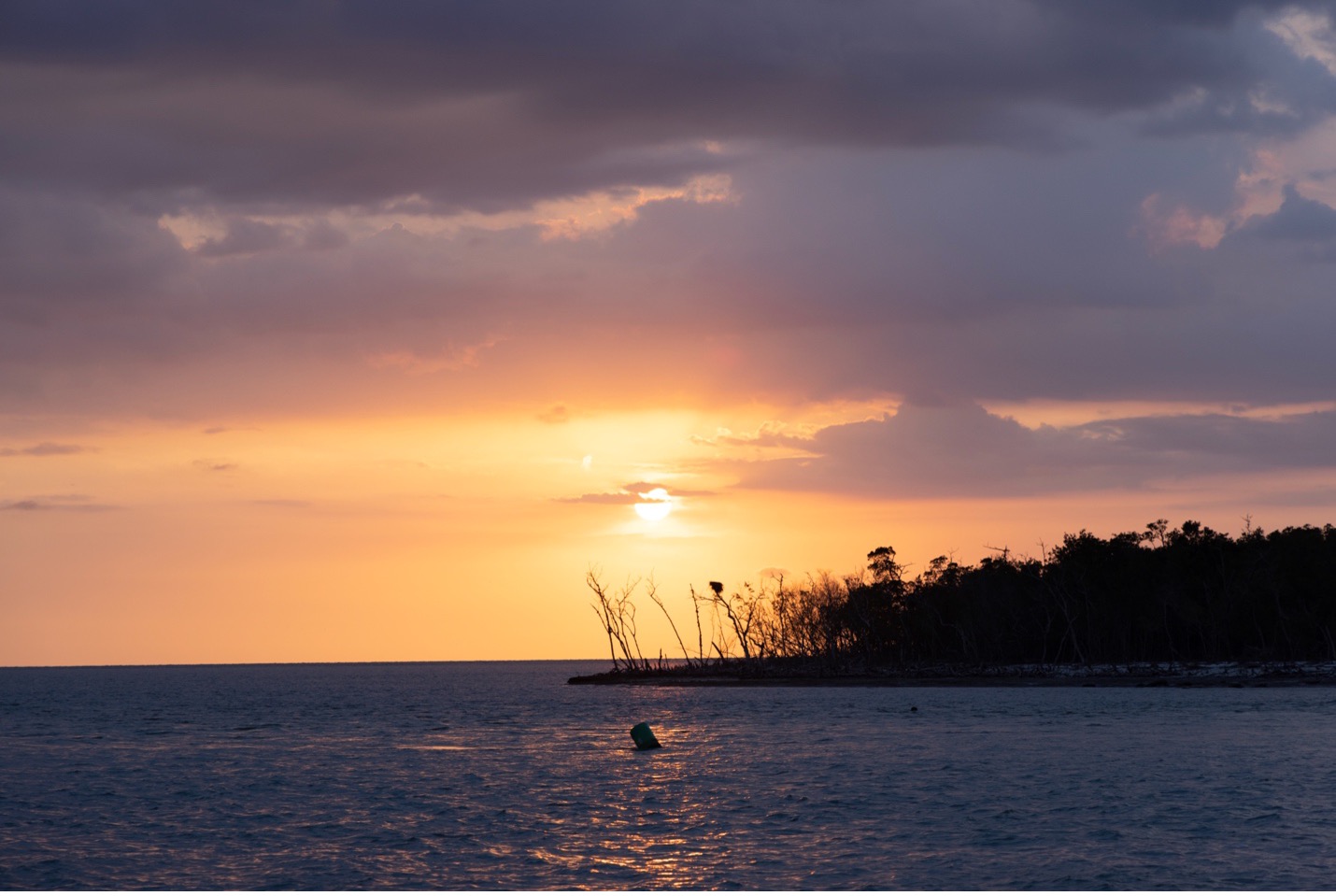 a Florida sunset shimmers over the cool blue ocean water