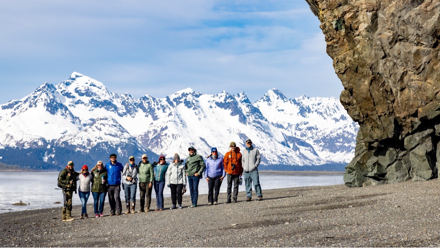 a group photo with marvelous mountains in the background