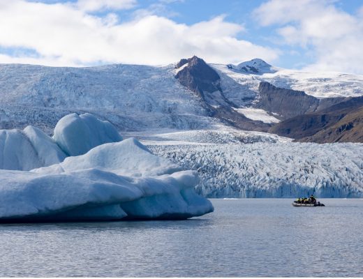 a boat cruises among icebergs in iceland