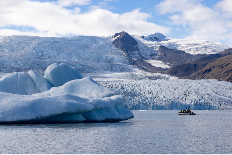 a boat cruises among icebergs in iceland