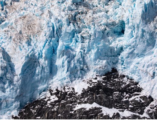 blue glacier above rock