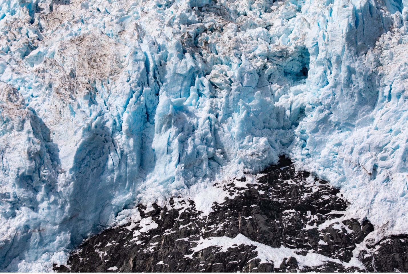 blue glacier above rock
