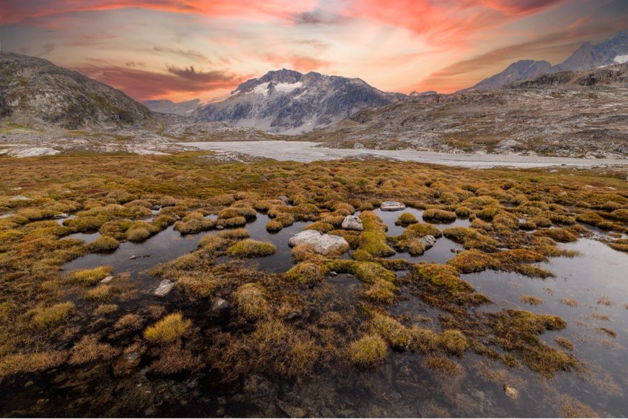 a beautiful sunset over a valley in Greenland