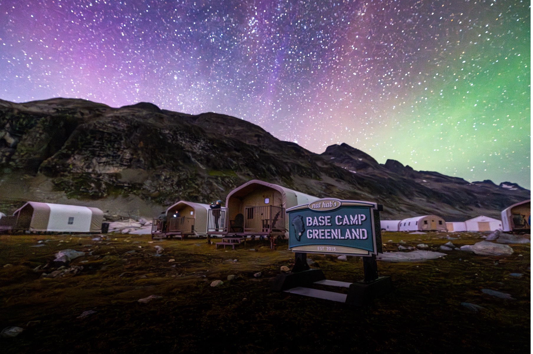 northern lights dance above base camp greenland