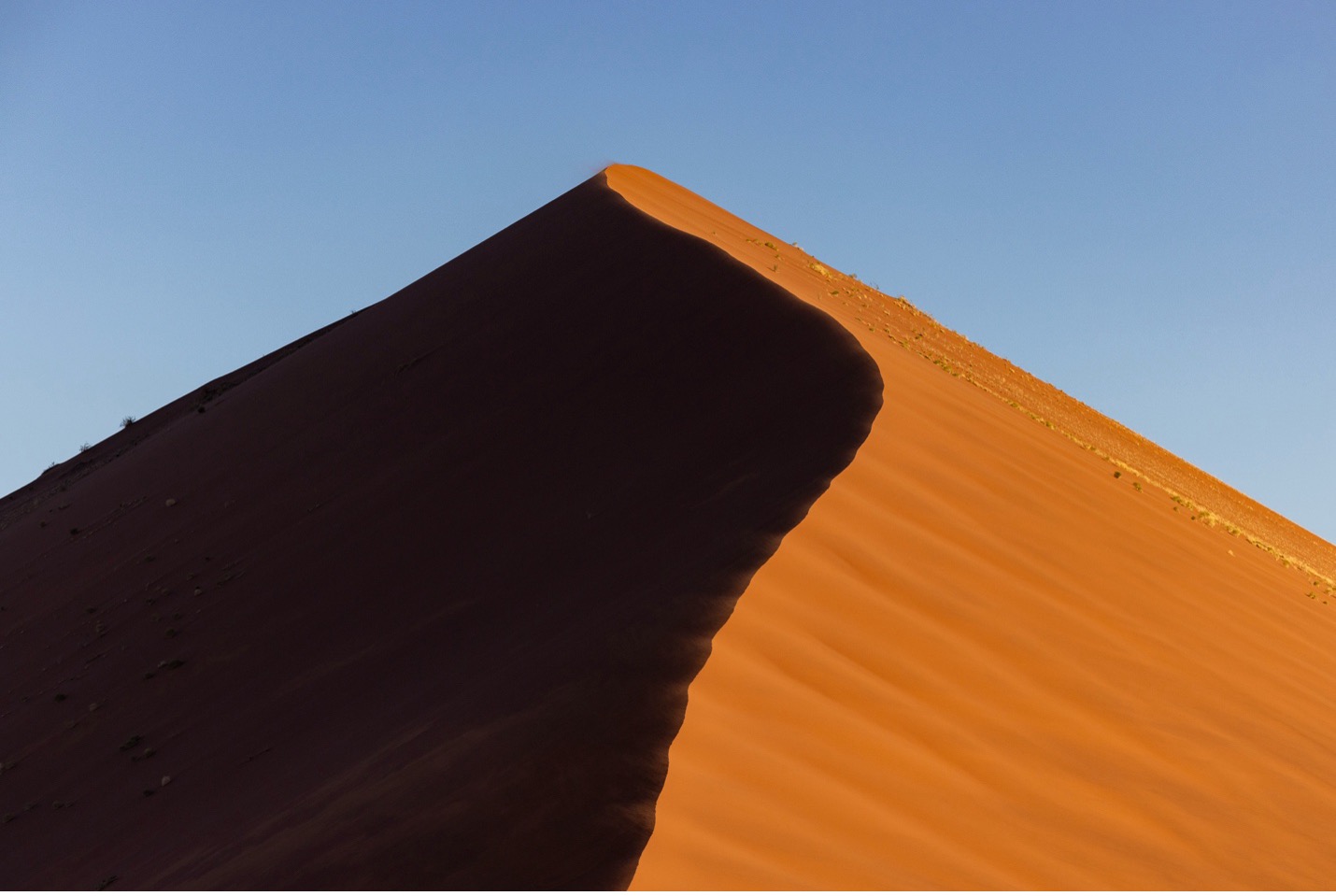 a symmetrical photo of a single dune in Namibia